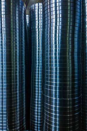 industrial manufacturing background of columns of shiny metal rings after cnc turning operation. Selective focus technique.の写真素材