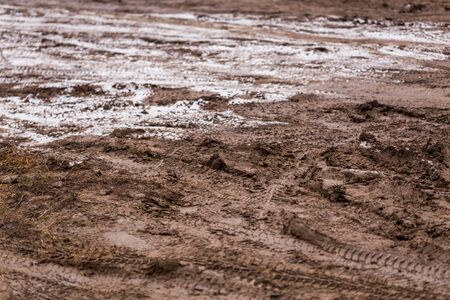 dirty mud road background at winter with selective focus and blurの写真素材