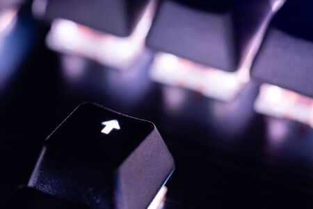 a close-up view of black mechanical pc keyboard with white backlightの写真素材