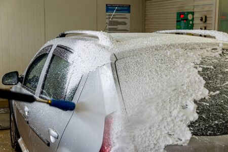 a car foam application process while washing indoors.の写真素材