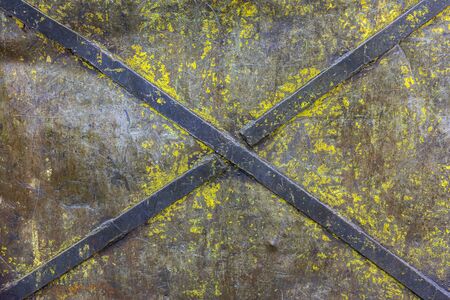obsolete painted industrial flat iron panel texture with welded steel diagonal cross stripes for rigidityの写真素材
