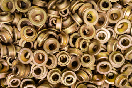 An abstract backround of yellow cadmium coated steel rings. Closeup with selective focus.の写真素材