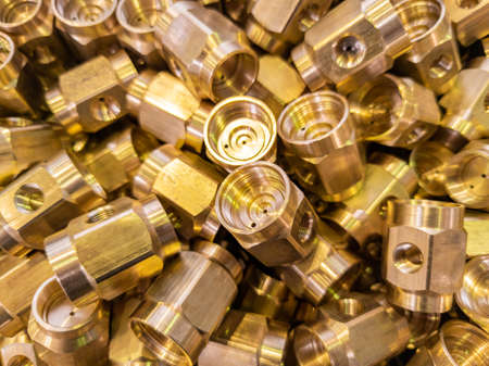 shiny brass parts background, chaotic disorder pile in close-up view with selective focus and dreamy blurの写真素材