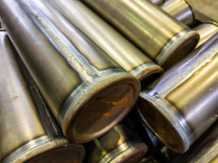 cylindrical steel tubes with tig argon arc welded seams - close-up industrial background with...