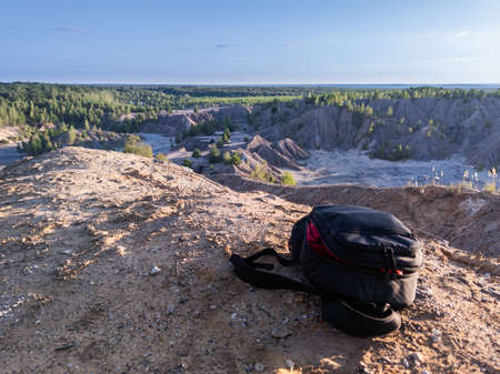small black backpack on top of the hill at summer daytime