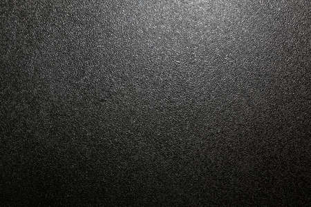 dark background of hammered powder paint coating on flat sheet steel surfaceの写真素材