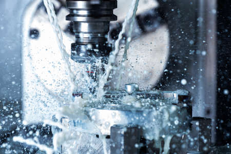 a process of vertical cnc steel milling with external water coolant streams and splashes