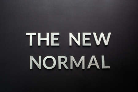 words the new normal on black surface in flat lay perspectiveの写真素材