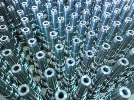 Shiny long steel parts full frame background, clean steel rods after fine cnc turning.