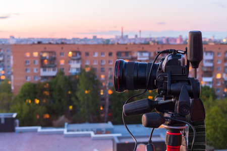 pro dslr on tripod in evening roof photoshoot
