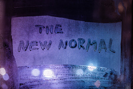 words the new normal handwritten on foggy night window glass surfaceの写真素材