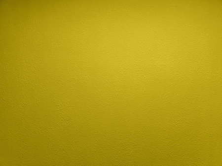 abstract yellow plaster wall flat full frame backgroundの写真素材