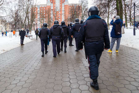 TULA, RUSSIA - JANUARY 23, 2021: Public mass meeting in support of Alexei Navalny, group of police officers going to arrest protesters.のeditorial素材