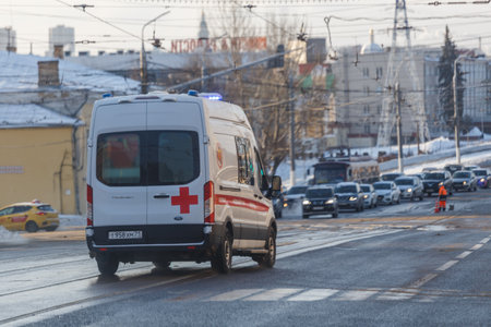 White ambulance minibus on winter wet street lane.のeditorial素材