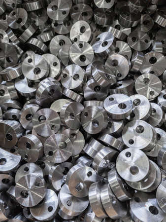 full frame view on heap of round steel cylindrical parts after eccentric drilling