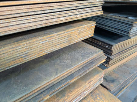 stacks of thick rusted flat metal sheets - close-up