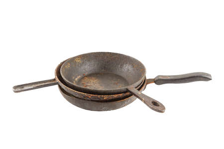 old disgusting stained rusty cast iron pan stack with burnt fat and food leftovers isolatedの写真素材