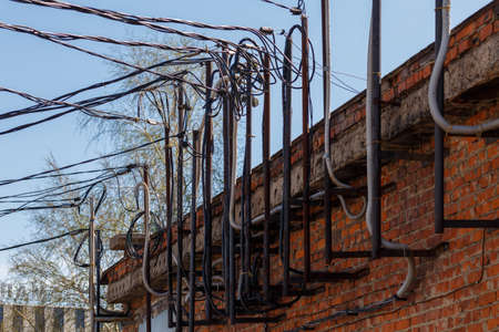 lots of wires sticking out of an old brick electrical substation buildingの写真素材