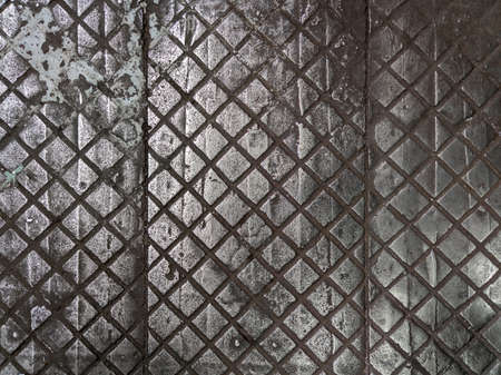 old cast iron factory floor tiles with checkered skid-proof patternの写真素材