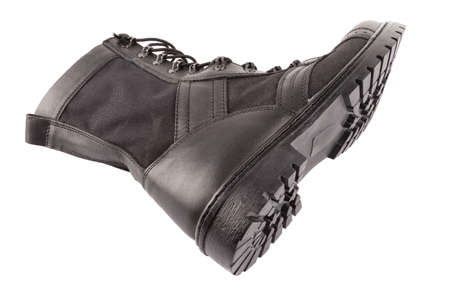 new black lightweight military boot isolated on white background, lying on its side