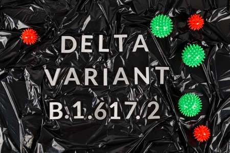words delta variant B.1.617 laid with silver metal letters on crumpled black plastic bag background in diagonal perspectiveの写真素材