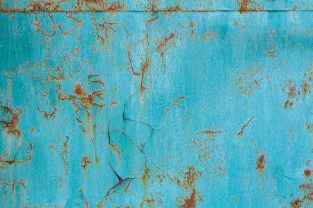 turquoise painted flat steel sheet with cracks and rust stains