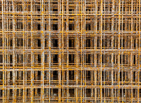 Thin rusty steel welded wire mesh for concrete reinforcing. Industrial material corrosion...