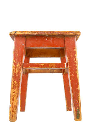 Old wooden stool with brown peeling paint. Loft style chair isolated on a white background.の写真素材
