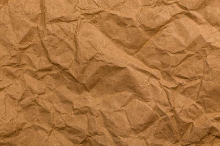Ragged crumpled brown kraft paper texture and full frame background