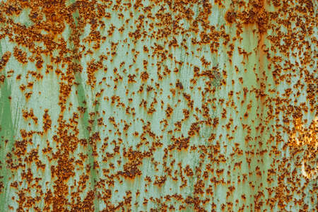 peeled off green paint on flat rusted sheet metal surface