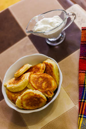 homemade Russian pancakes on ceramic bowl on dinner tableの写真素材