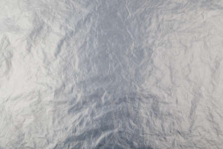full frame background of flat crumpled semi-transparent polyethylene film