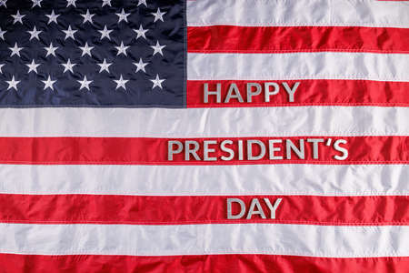 words happy presitdents day laid with real letters on US flag surface