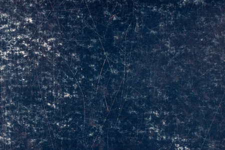 scratched dark blue surface of painted cardboard, flat full-frame background and texture