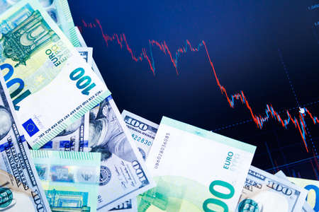 dollar and euro banknotes over digital screen with exchange chart, USD EUR parity concept
