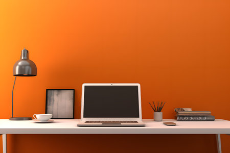 Laptop computer on desk in office in front of an orange wall, neural network generated imageの素材
