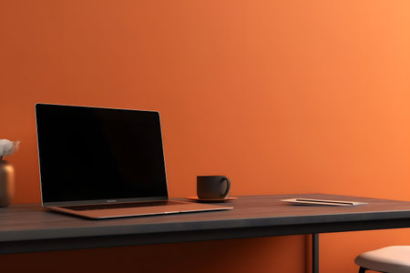 Laptop computer on desk in office in front of an orange wall, neural network generated imageの素材