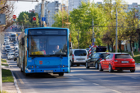 blue bus with car traffic at summer day in Tula, Russiaのeditorial素材