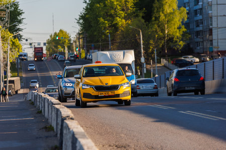 yellow taxi with car traffic at summer day in Tula, Russiaのeditorial素材