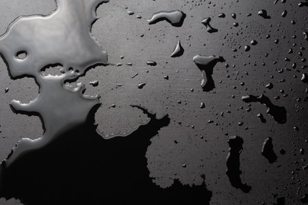 abstract background of wet black clean painted surface - close-up with selective focusの写真素材