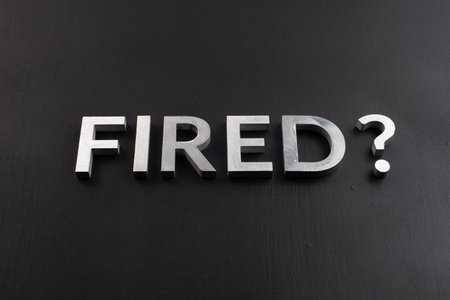 the question fired laid with silver metal letters on flat black surfaceの写真素材