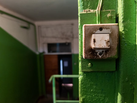 dirty light switch in a residential building corridor
