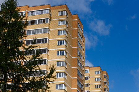 new high rise brick apartment buildings with spruce tree.の写真素材