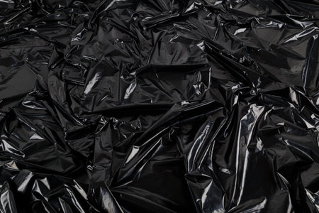 full-frame abstract background of crumpled black plastic film bag.の写真素材