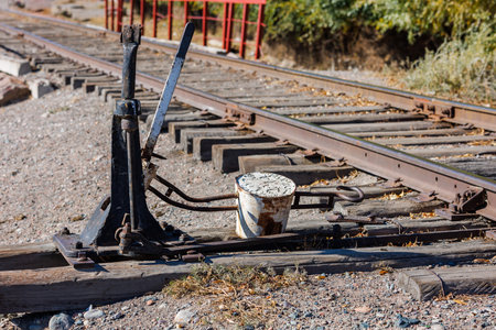 manual railroad switch with lever and counterweight at summer dayの写真素材