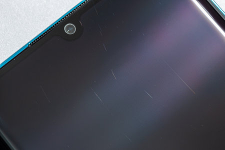 tiny scratches on clean used contemporary smartphone screen surface, macro photoの写真素材