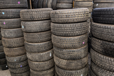 stacks of used good condition tires for cars, close full-frame backgroundの写真素材