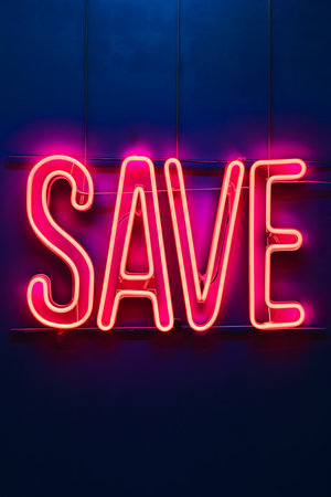 Neon word SAVE on dark shabby wallの素材