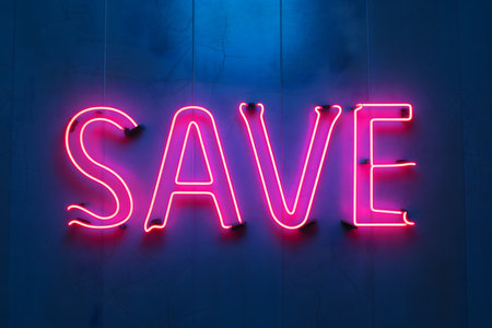 Neon word SAVE on dark shabby wallの素材