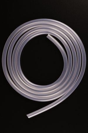 transparent plastic tube coil on black backgroundの写真素材